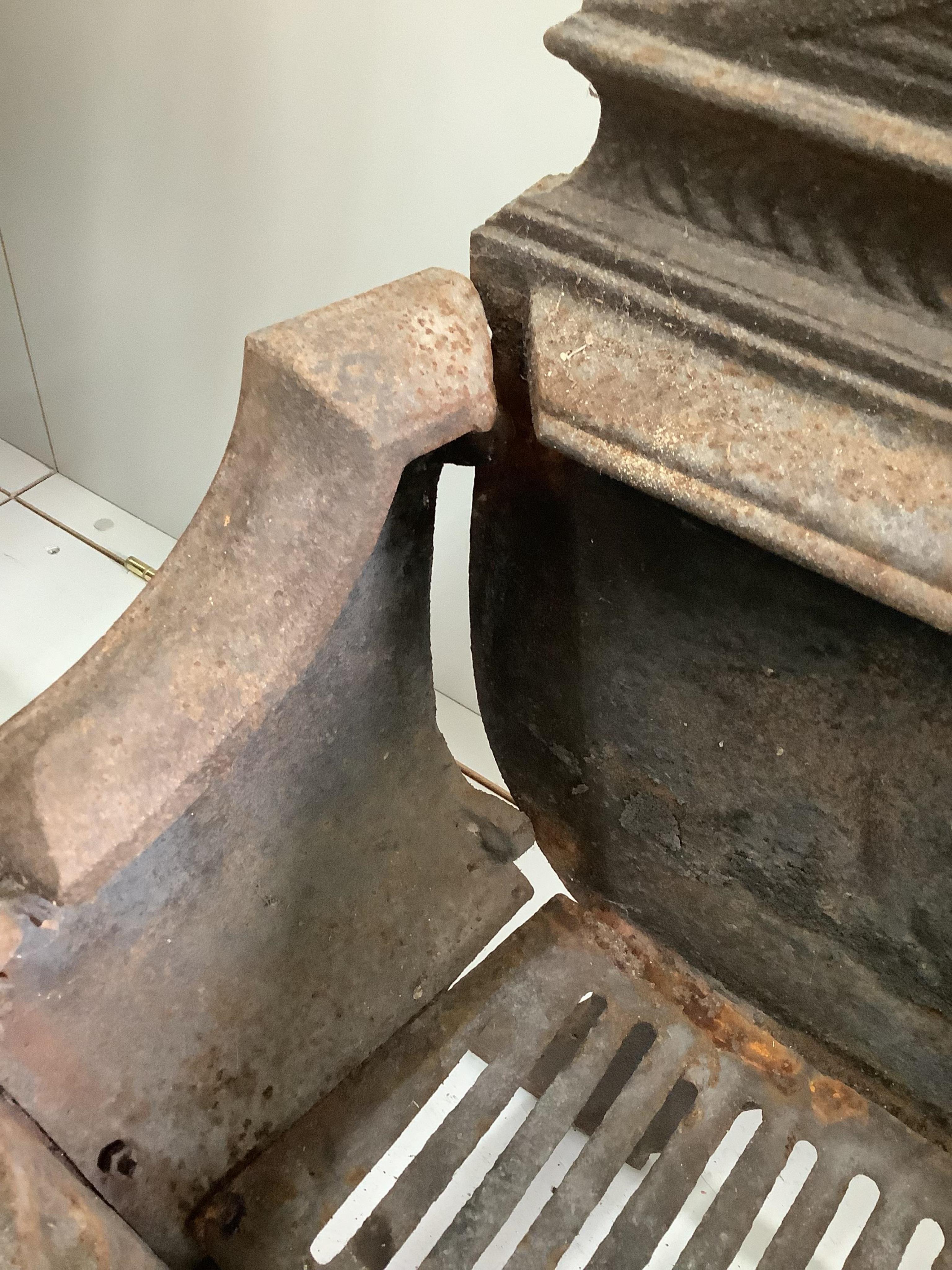 A George III style brass mounted cast iron serpentine fire grate, (lacking side bolts), width 56cm, depth 30cm, height 64cm. Condition - poor